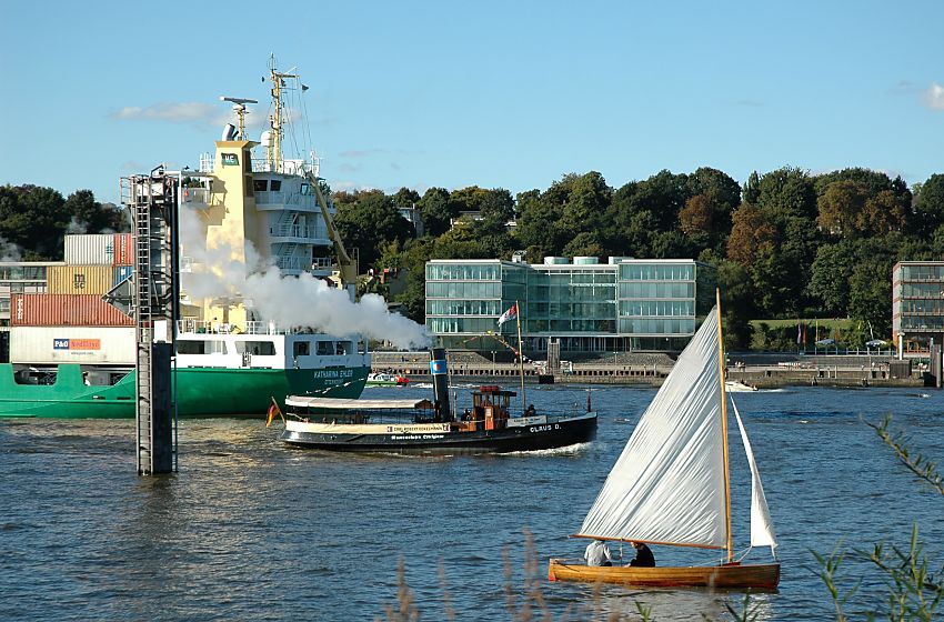 011_22976/00 ein Containerschiff fhrt auf der Elbe in Hhe Hamburg Neumhlen Richtung Nordsee; der historische Schlepper dampft Richtung Hafen - ein Segelboot segelt am Elbufer - an der anderen Elbseite die neue Architektur Hamburgs im ehem. Hafengebiet Altonas.  www.fotograf-hamburg.de