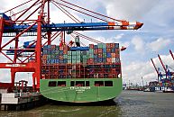 011_15611 das imposante Heck eines Containerschiffs am Kai vom Eurogate Terminal im Waltershofer Hafen - die Frachtcontainer sind auf der XIN LOS ANGELES in mehreren Reihen hoch gestapelt - ein Container schwebt unter der Containerbrcke und wird an Land gebracht; links unten warten schon die Container Carrier, um die Fracht weiter zu transportieren.