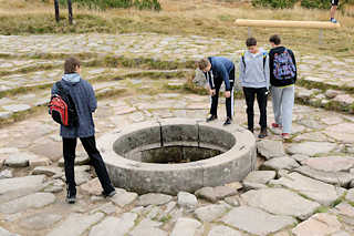 5653 Die gemauerte Wasserfassung der Elbquelle /  Prameny Labe auf der Hochebene im Riesengebirge Krkonoše, 1387 ber dem Meeresspiegel gelegen -  - Touristen blicken in das Wasser.