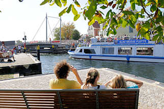 9309 Ein Ausflugsschiff der Blau Weissen Flotte mit Touristen an Bord an der geffneten Drehbrcke in Malchow - Touristen fotografieren das Fahrgastschiff.